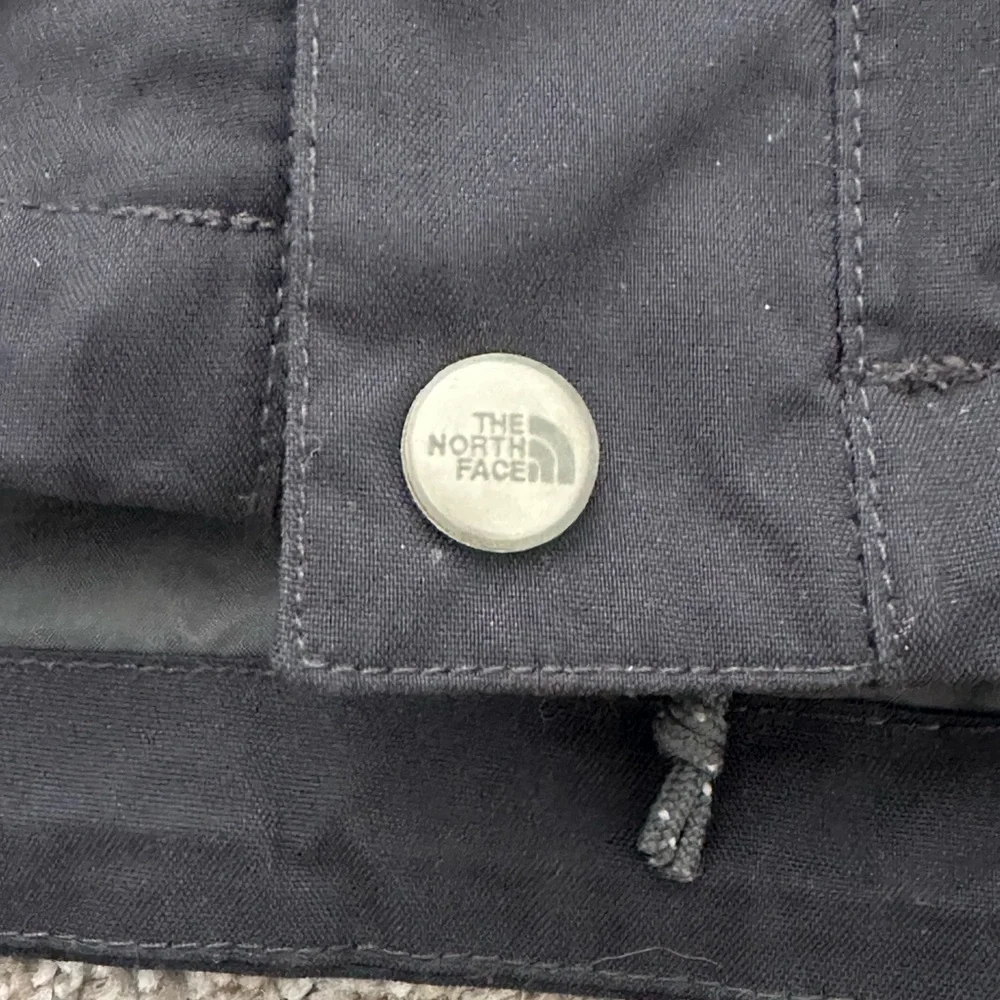 The North Face Black Hooded Raincoat with Multiple Front Pockets